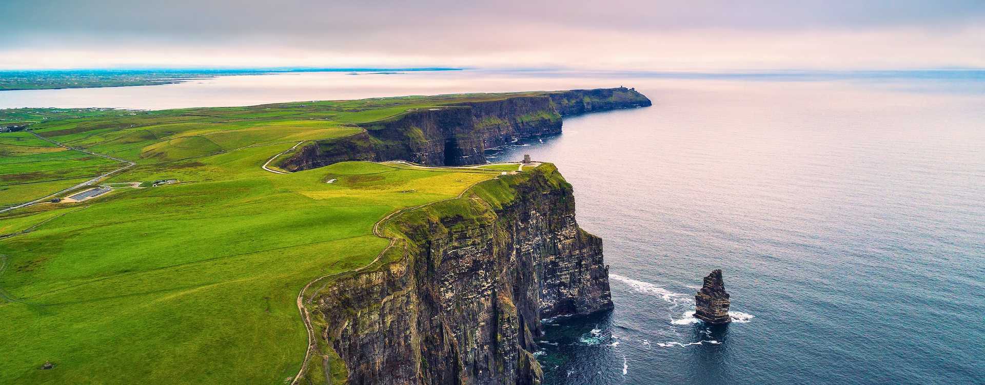 Cliffs of Moher scenery – Book the best guided tours, bus day trips and private excursions from Dublin and Galway in 2026 Panoramic view of the Cliffs of Moher coastline and O'Brien's Tower in Ireland – Top destination for guided tours, day trips and private excursions in 2026